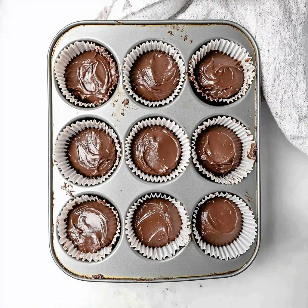 Chocolate coconut cupcake batter in cupcake liners ready to bake
