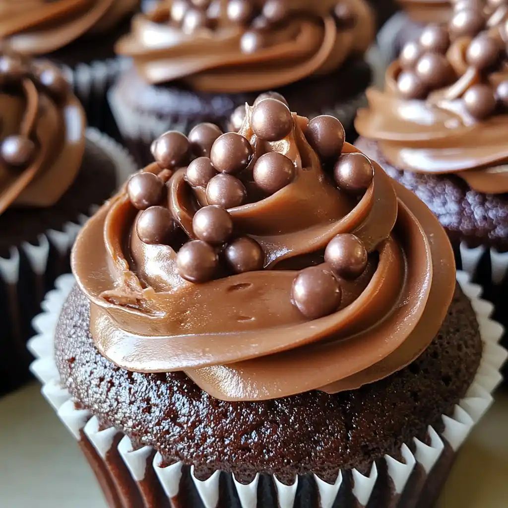 Chocolate fudge cupcakes with ganache and pearls