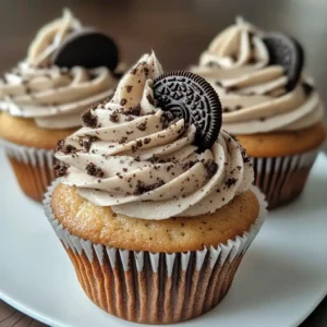 Cookies and cream cupcakes with Oreo buttercream frosting topped with Oreo halves.