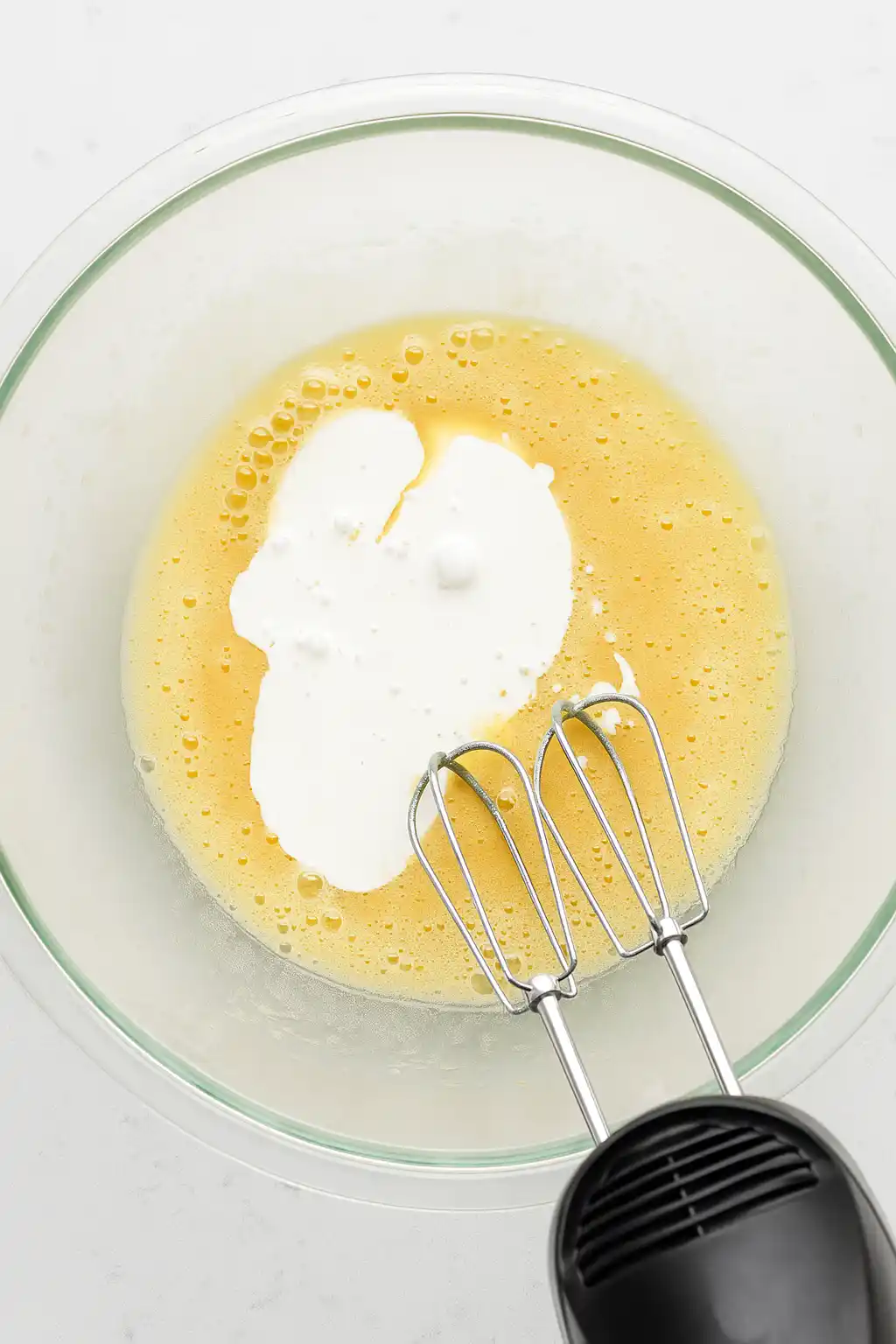 mixing dairy free cupcake batter in a bowl