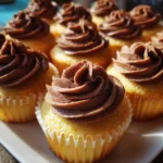 vanilla cupcakes with chocolate frosting on white plate