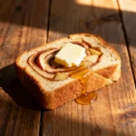 Apple Cinnamon Bread recipe card with ingredients and baking steps displayed on a rustic kitchen counter